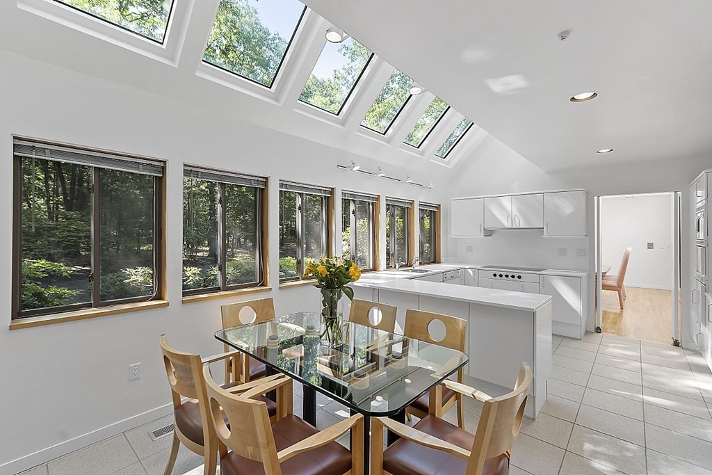70 Davison Drive Lincoln, MA 01773 - Photo 9 of 37 a view of a dining room with furniture large windows and wooden floor
