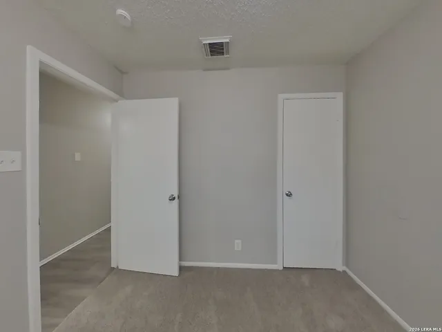 an empty room with closet area