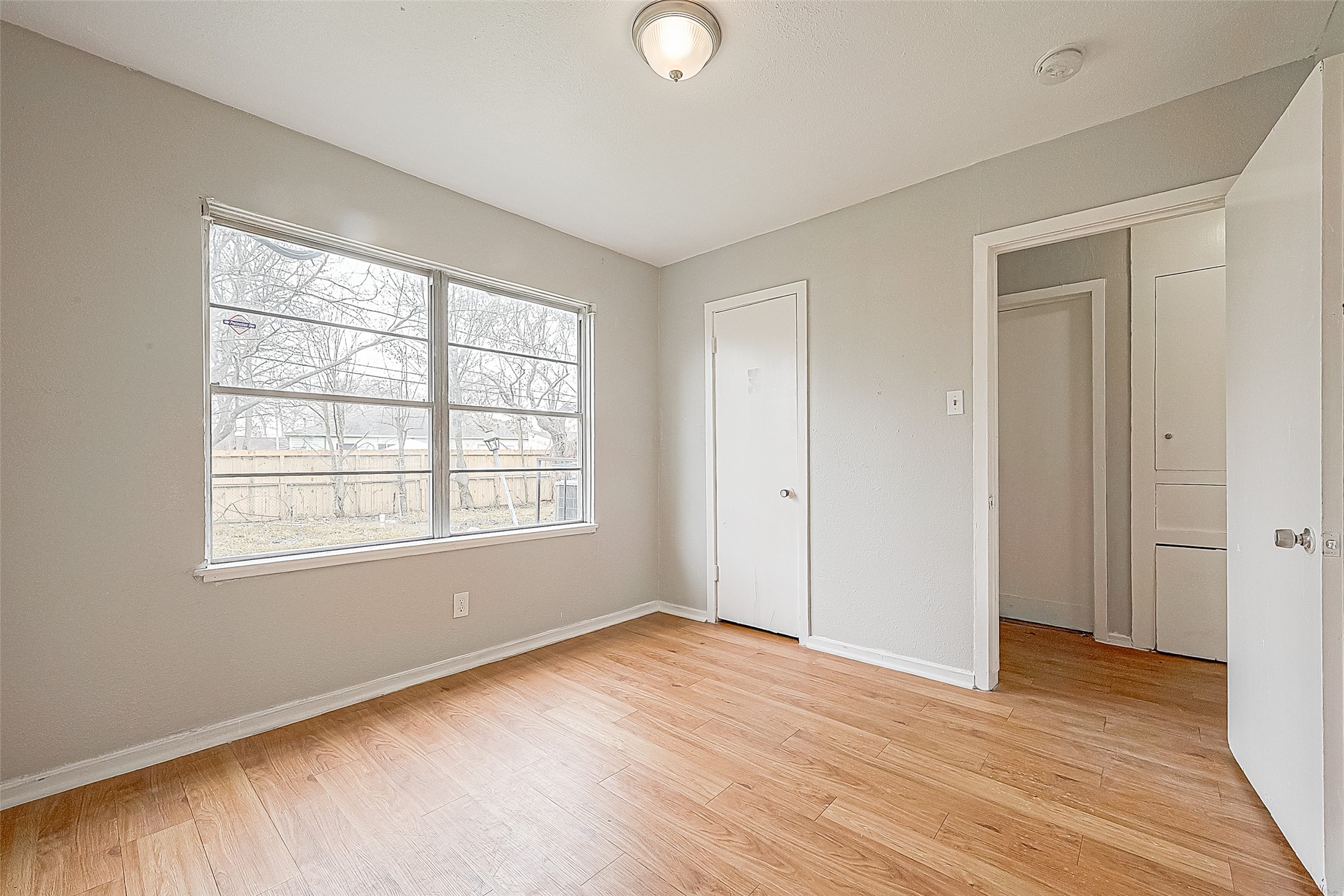 4910 Paradise Lane Houston, TX 77048 - Photo 11 of 15 a view of an empty room with wooden floor and a window