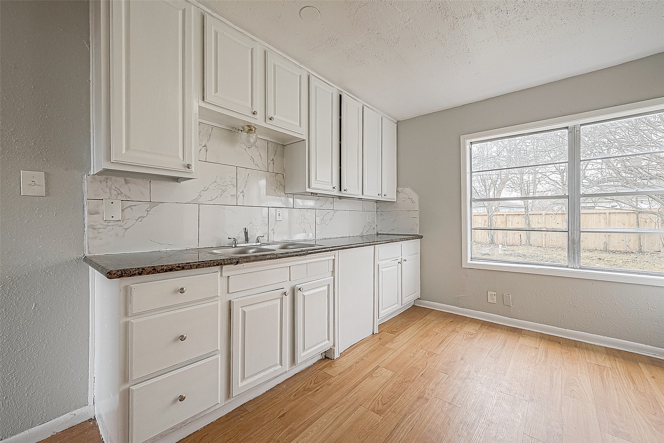 4910 Paradise Lane Houston, TX 77048 - Photo 6 of 15 a kitchen with granite countertop white cabinets and a sink