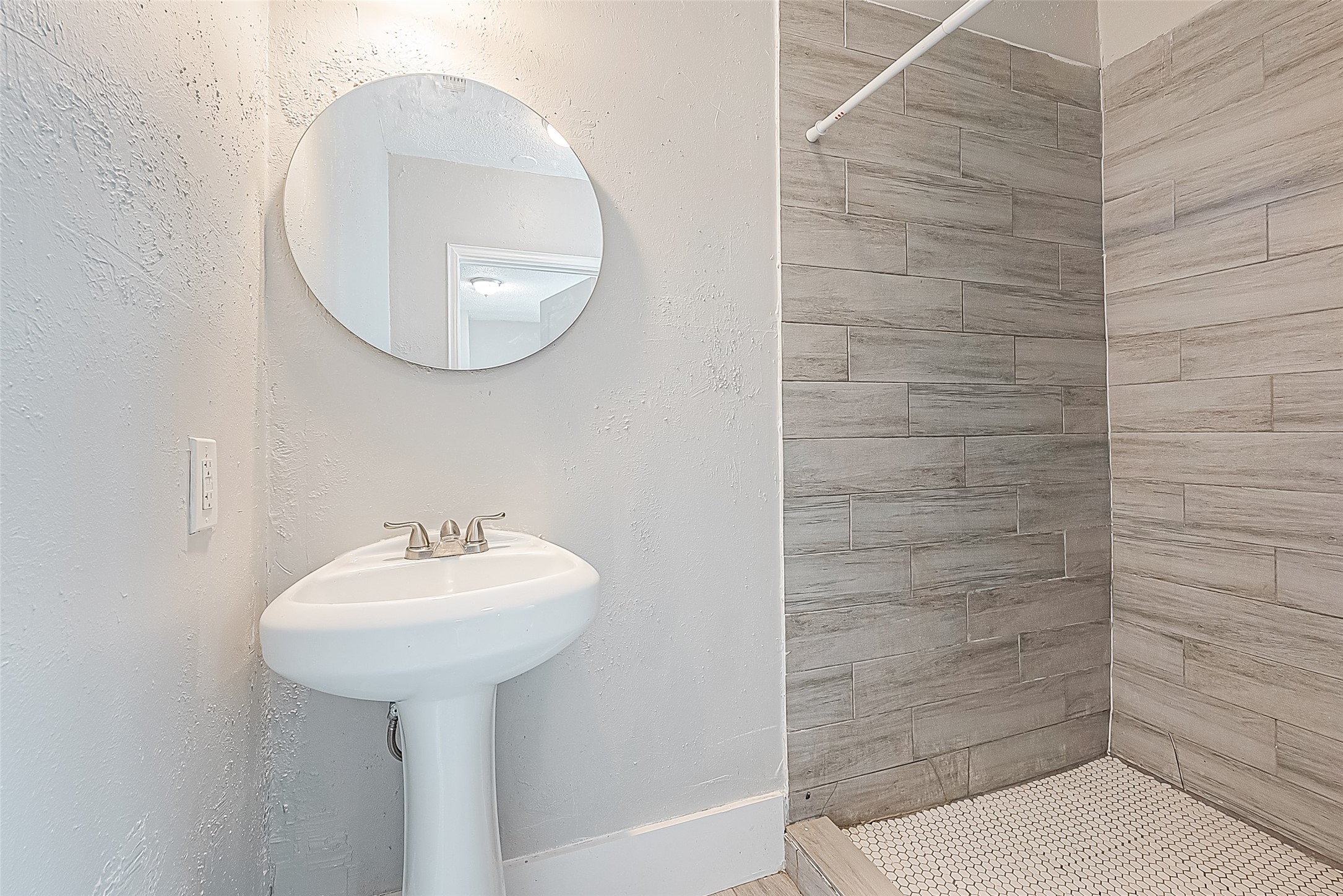 4910 Paradise Lane Houston, TX 77048 - Photo 7 of 15 a bathroom with a sink a mirror and a shower