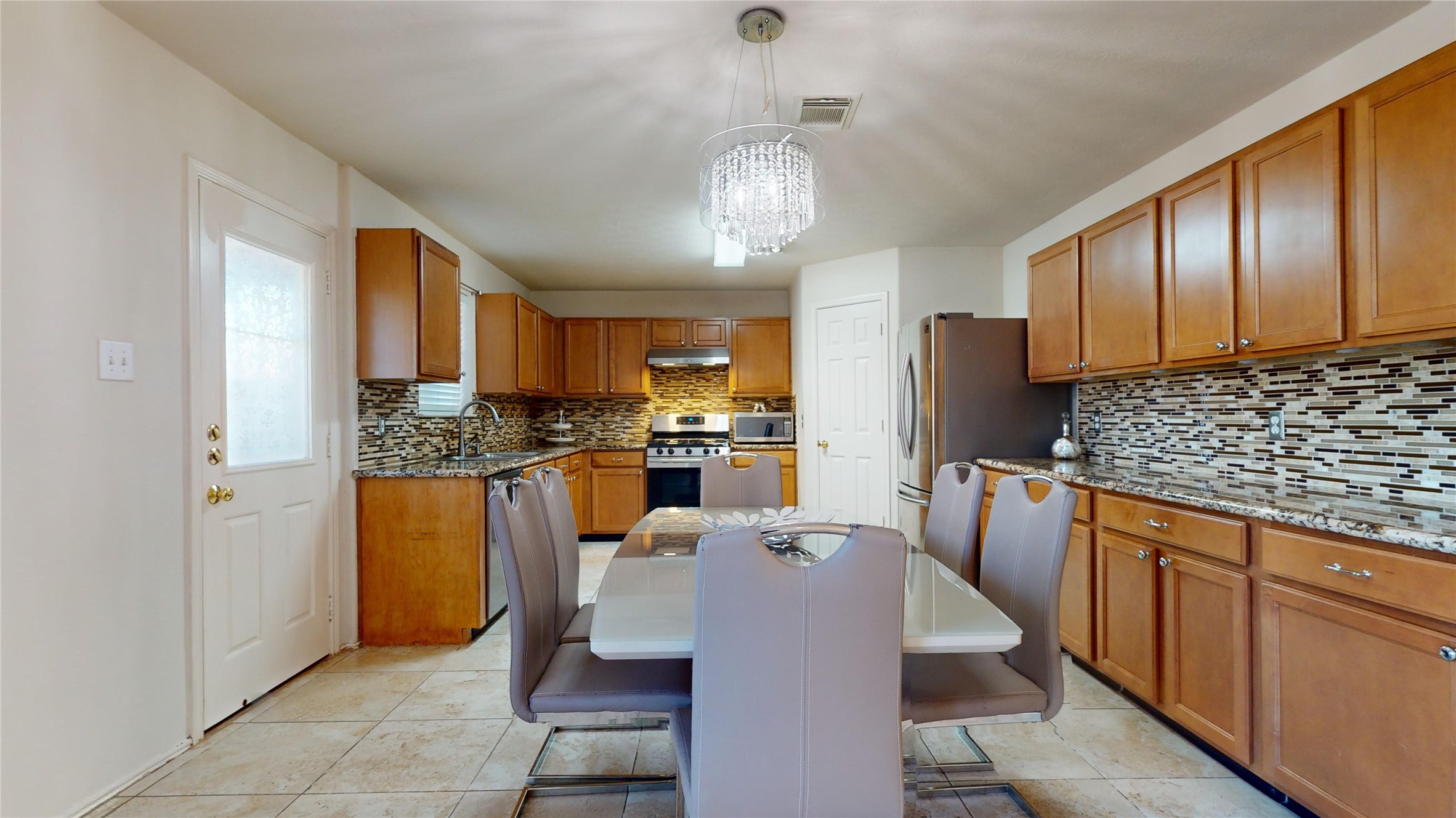 18226 Thicket Grove Road Houston, TX 77084 - Photo 15 of 45 a kitchen with refrigerator a sink and cabinets