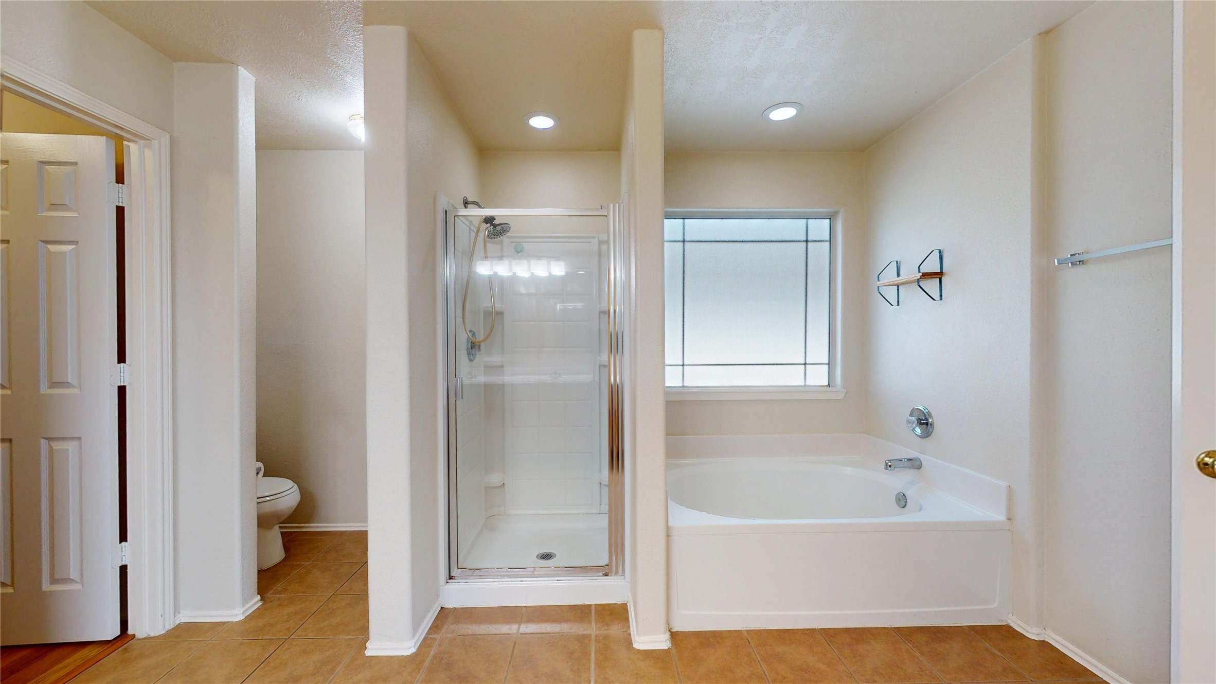 18226 Thicket Grove Road Houston, TX 77084 - Photo 28 of 45 a bathroom with a bathtub and a shower