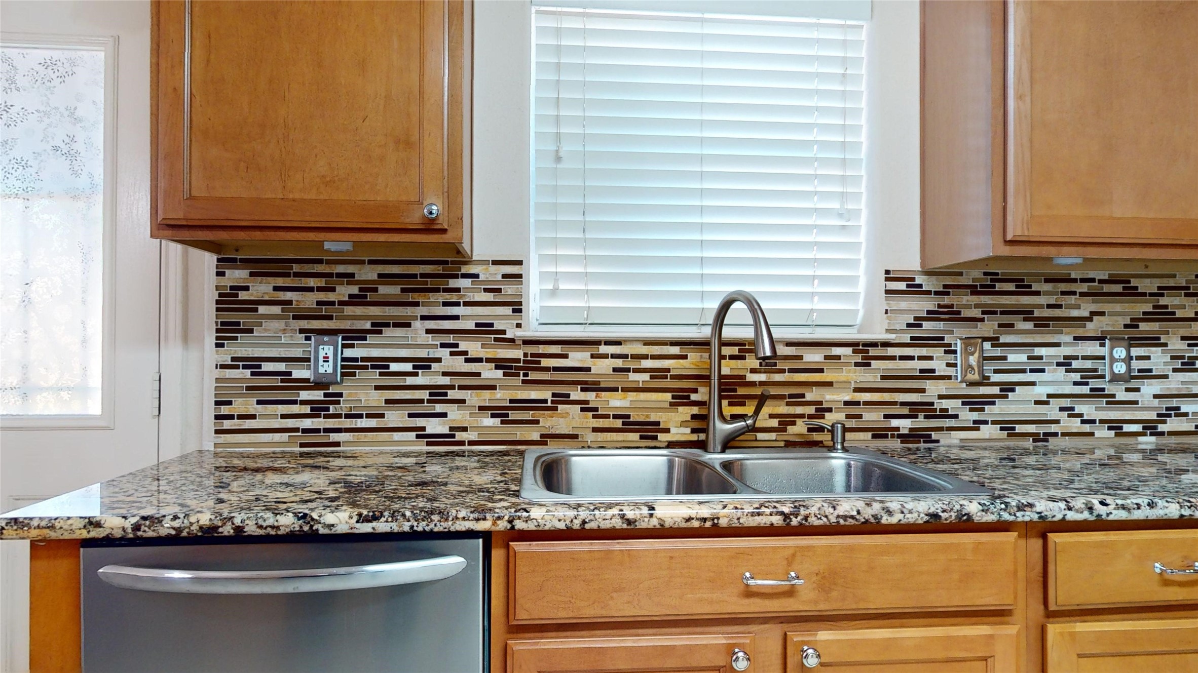 18226 Thicket Grove Road Houston, TX 77084 - Photo 10 of 45 a bathroom with a granite countertop sink and a mirror