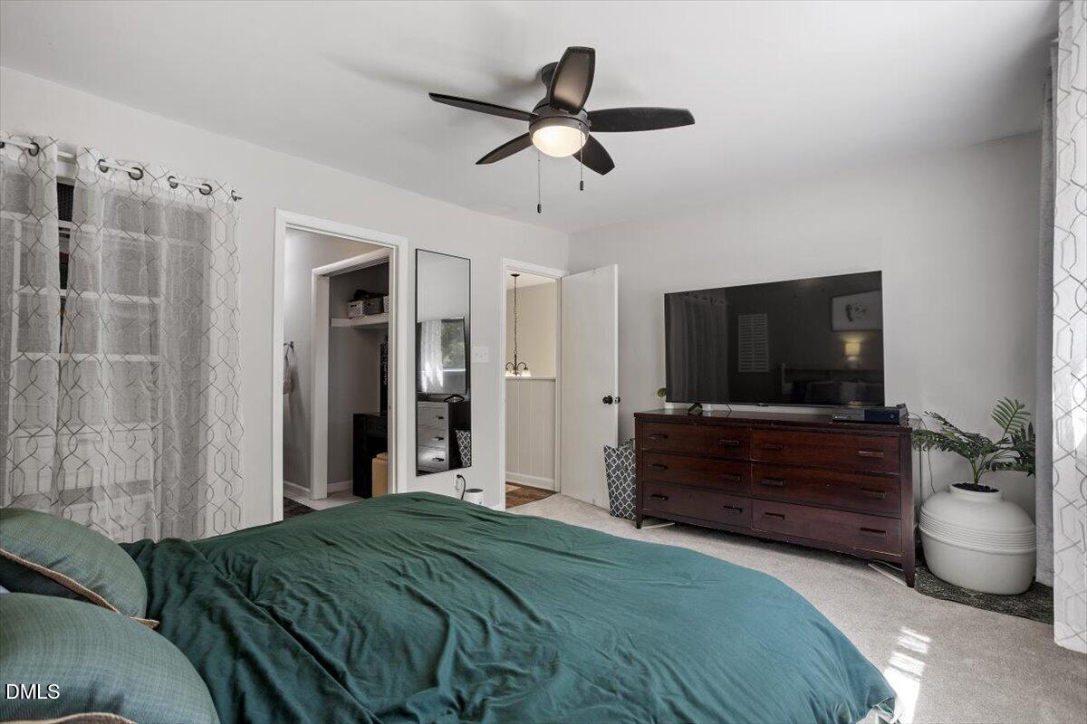 5045 Tall Pines Court Raleigh, NC 27609 - Photo 22 of 37 a bedroom with a bed and a flat screen tv