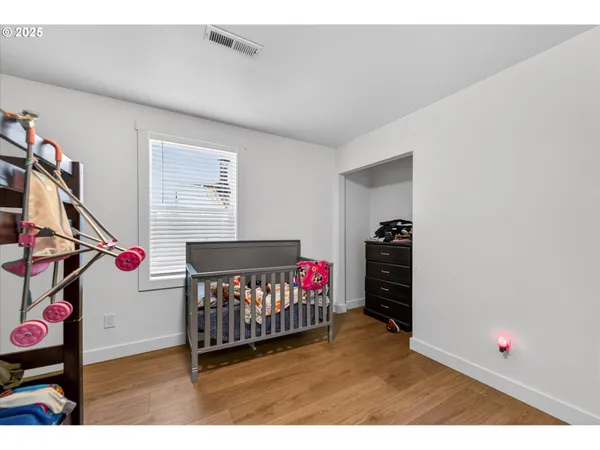 a living room with furniture a flat screen tv and a window