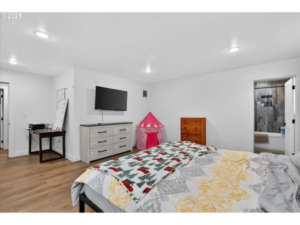 a bedroom with a bed and a flat screen tv