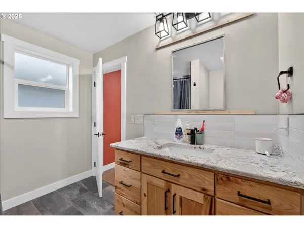 a bathroom with a sink vanity and mirror