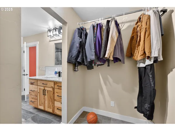 a view of walk in closet with clothes and shoes