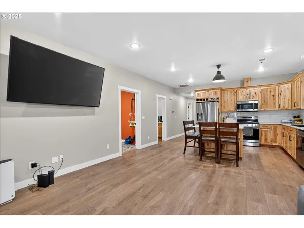 a view of a livingroom with furniture and a flat screen tv