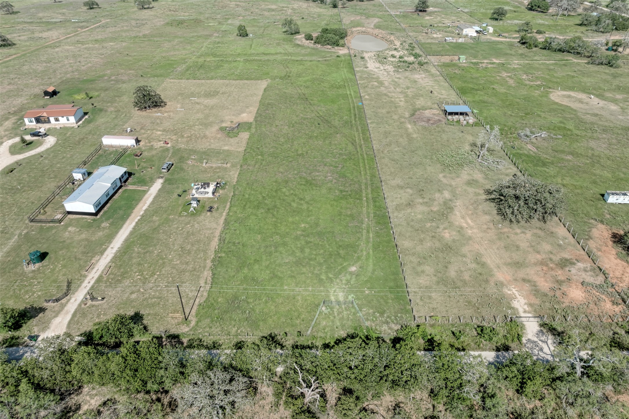 5309 Tenney Creek Road Luling, TX 78648 - Photo 9 of 23 Sprawling rural property with multiple outbuildings and an irrigation pond.