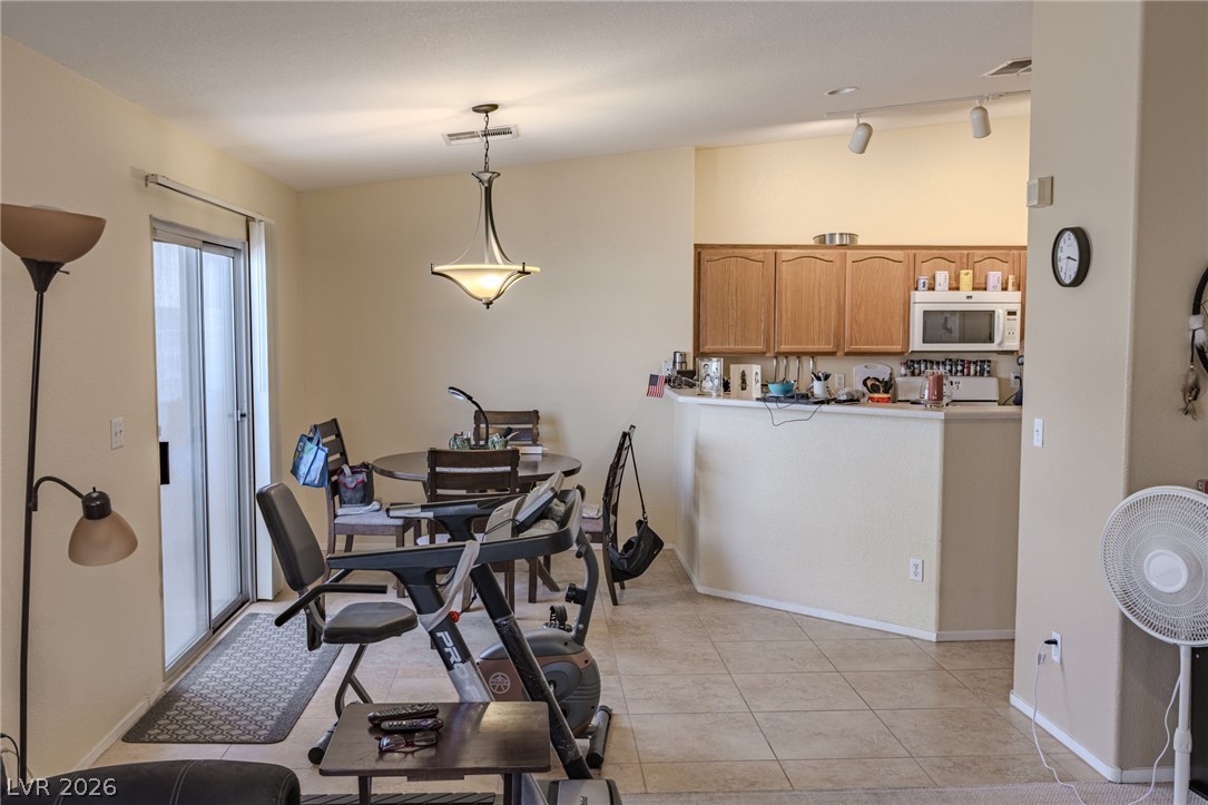 4994 Mascaro Drive Las Vegas, NV 89122 - Photo 5 of 30 An inviting open-concept layout features a well-appointed kitchen and convenient sliding glass doors.