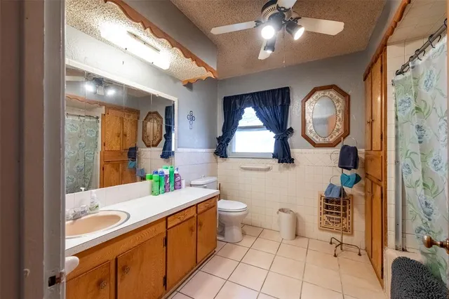 a bathroom with a double vanity sink mirror and toilet