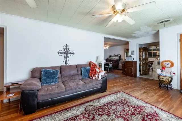 a living room with furniture and a view of bedroom