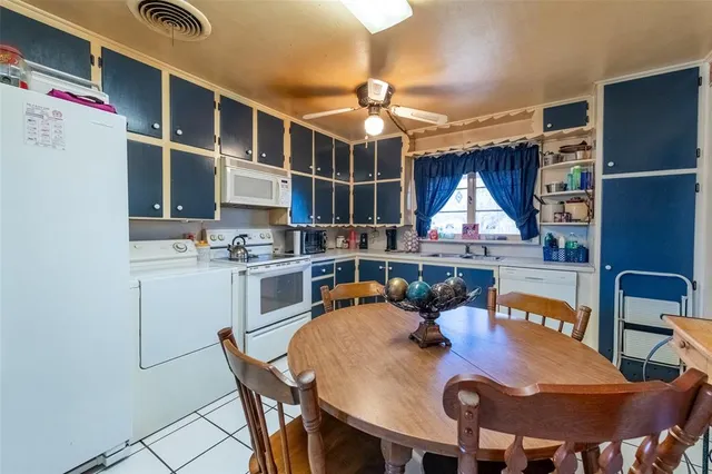 a dinning table and chairs in a open kitchen