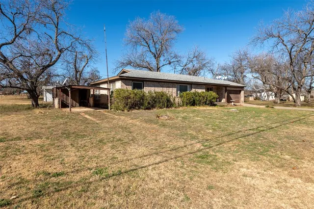 a view of a house with a snow in front of yard