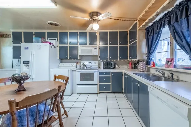 a kitchen with a table chairs and a window