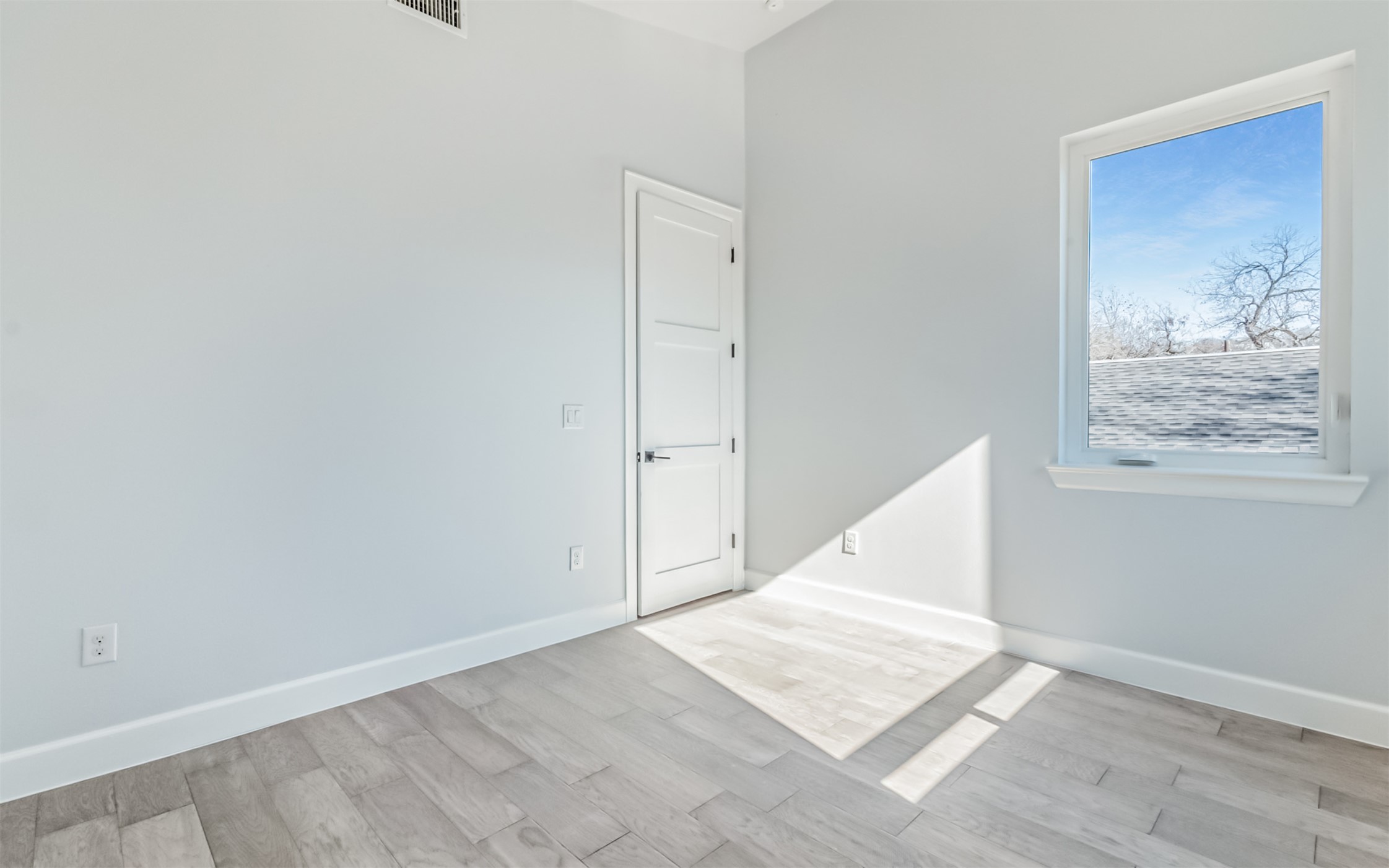 1130 Spur Street, Unit A Austin, TX 78721 - Photo 18 of 31 Unfurnished 2nd bedroom with two closets, vaulted ceiling, ceiling fan, and natural light