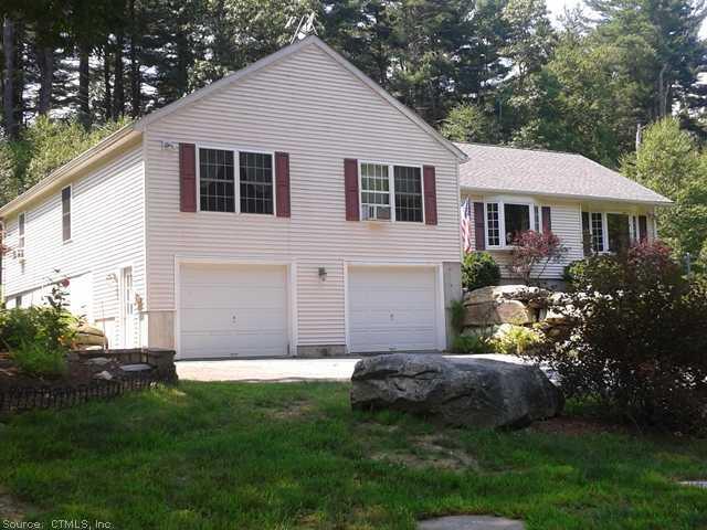 79 Hagstrom Road Thompson, CT 06255 - Photo 1 of 1 a view of a backyard with plants and large tree