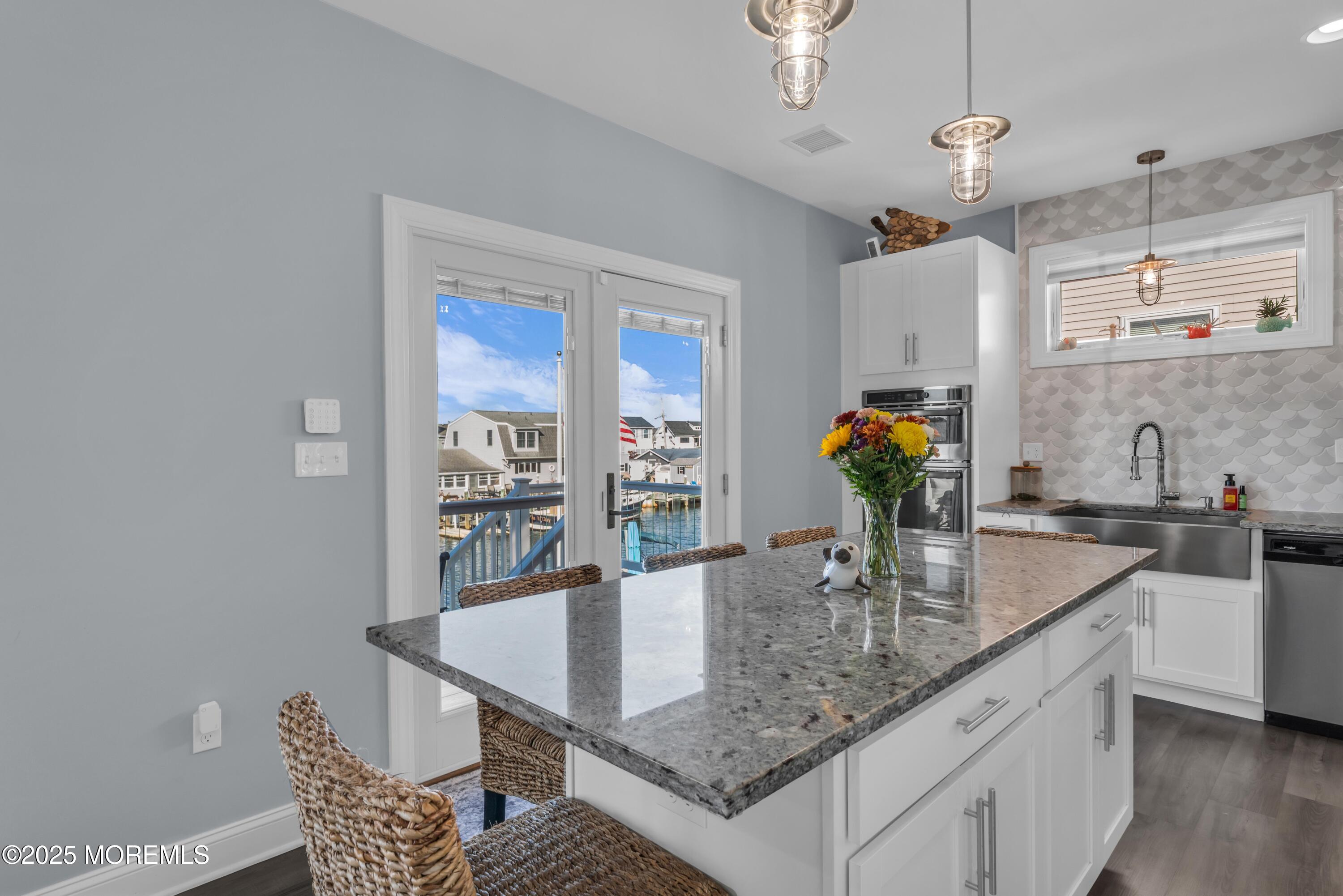 21 Compass Road Waretown, NJ 08758 - Photo 12 of 46 a dining room with furniture and wooden floor