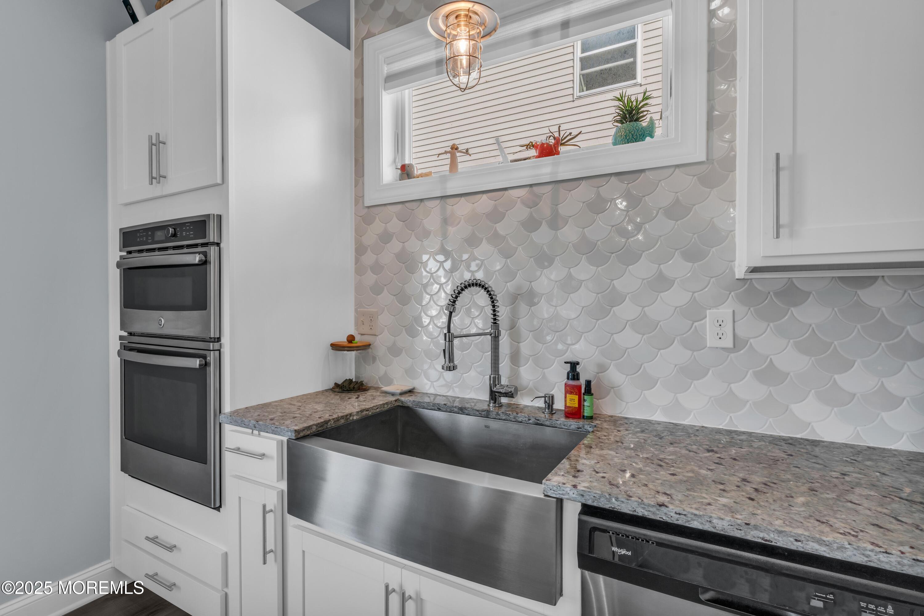 21 Compass Road Waretown, NJ 08758 - Photo 14 of 46 a kitchen with granite countertop a sink and a stove