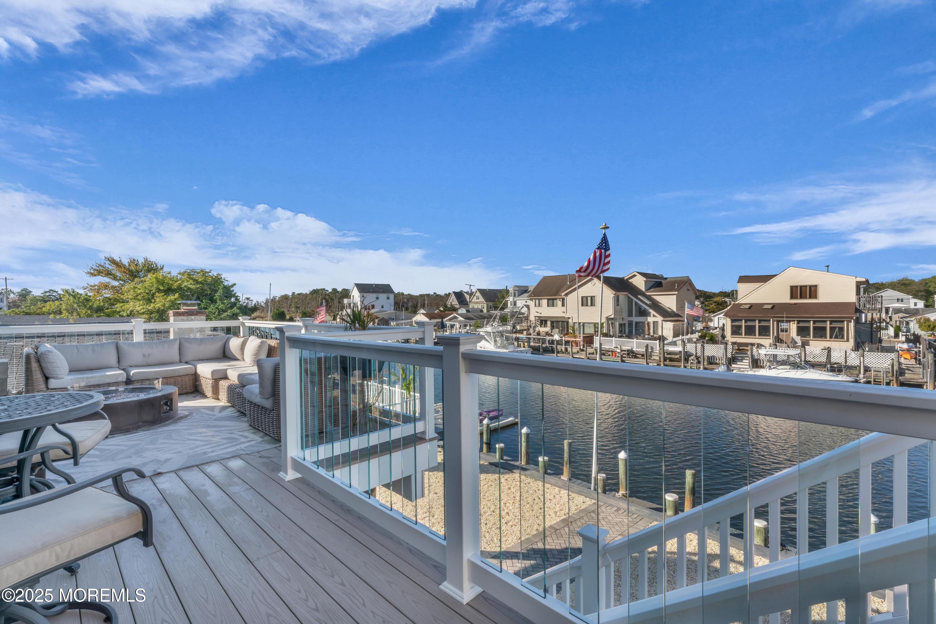 21 Compass Road Waretown, NJ 08758 - Photo 16 of 46 a view of a balcony with wooden floor and city view