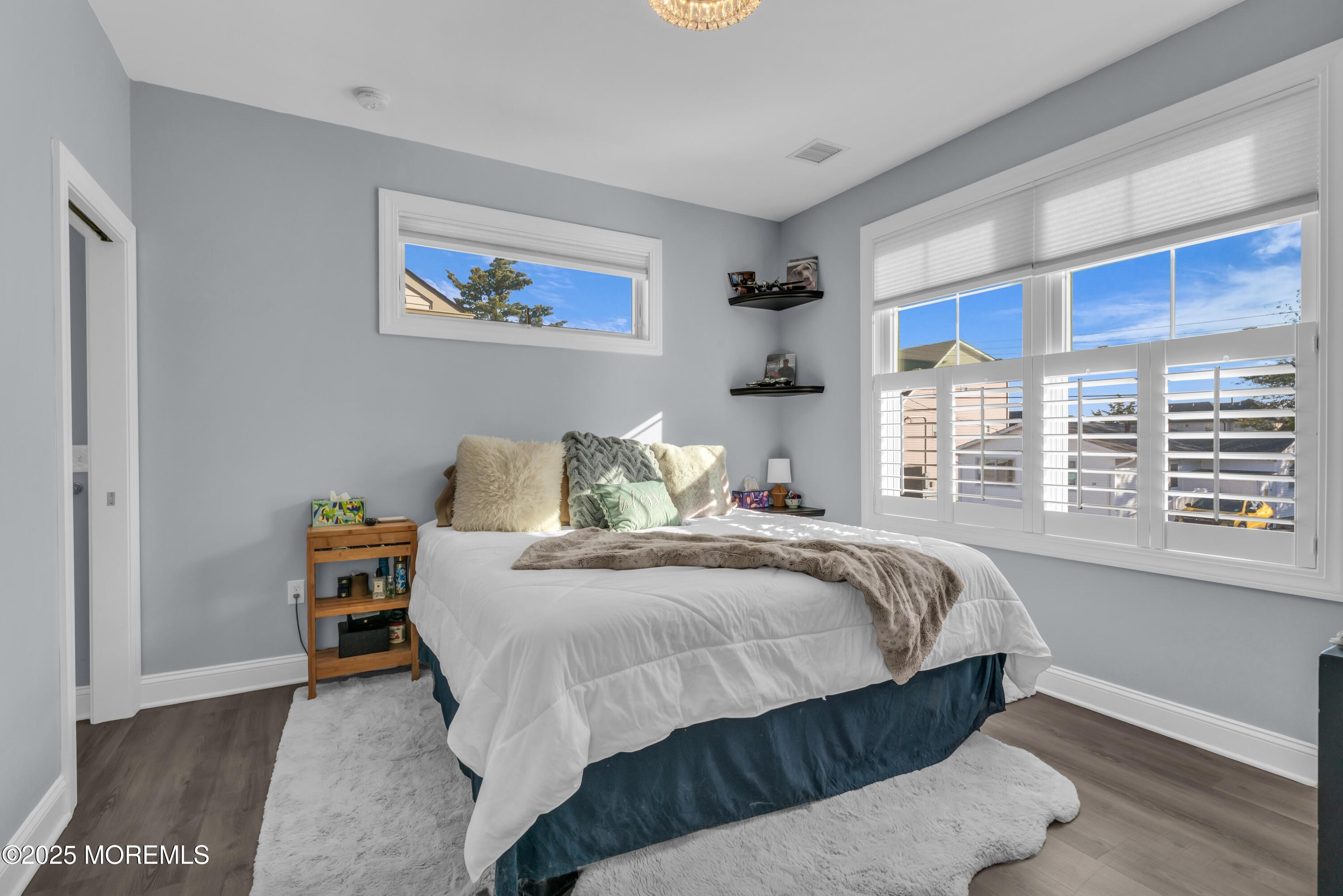 21 Compass Road Waretown, NJ 08758 - Photo 18 of 46 a bedroom with a bed and a large window