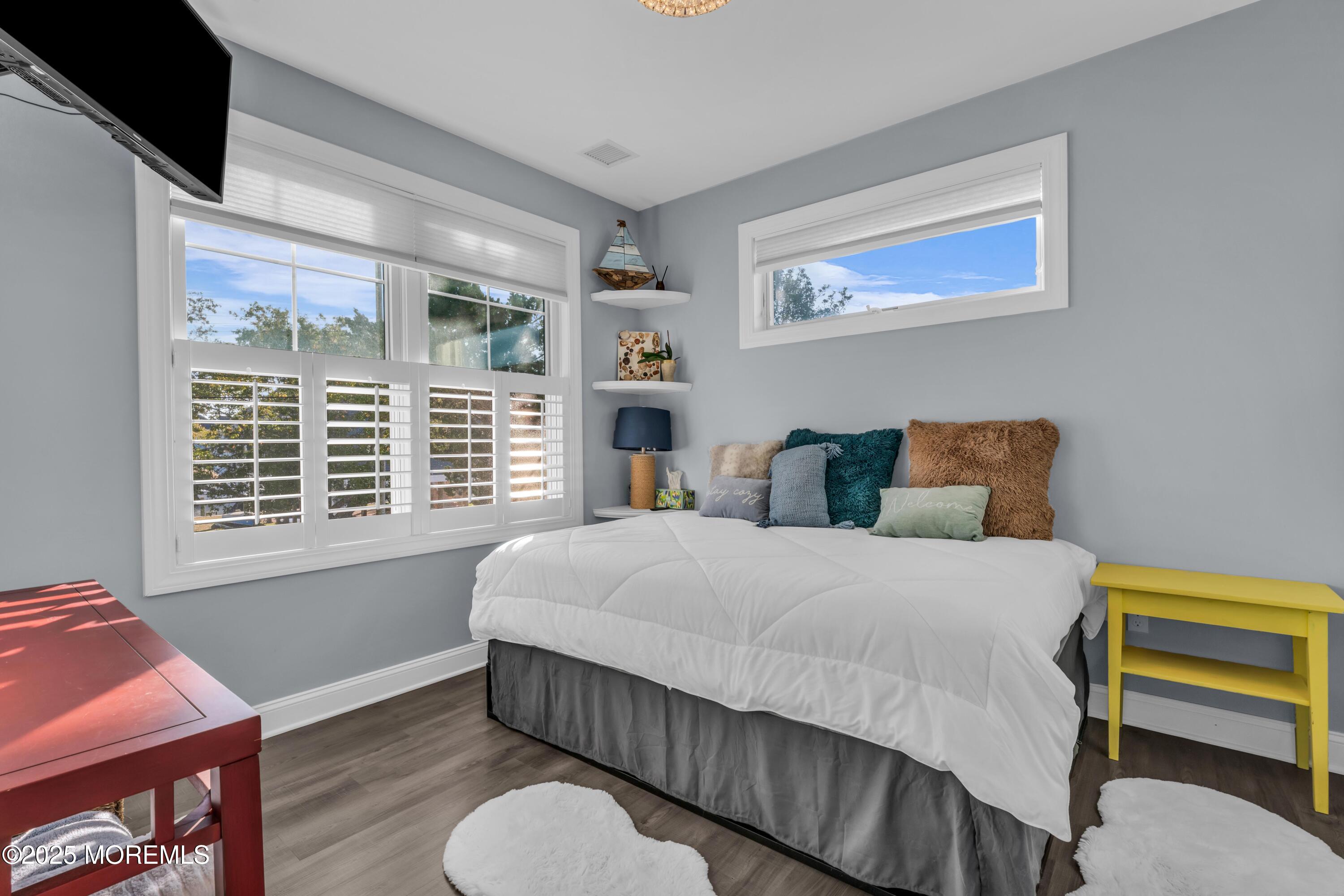 21 Compass Road Waretown, NJ 08758 - Photo 22 of 46 a bedroom with a bed and wooden floor