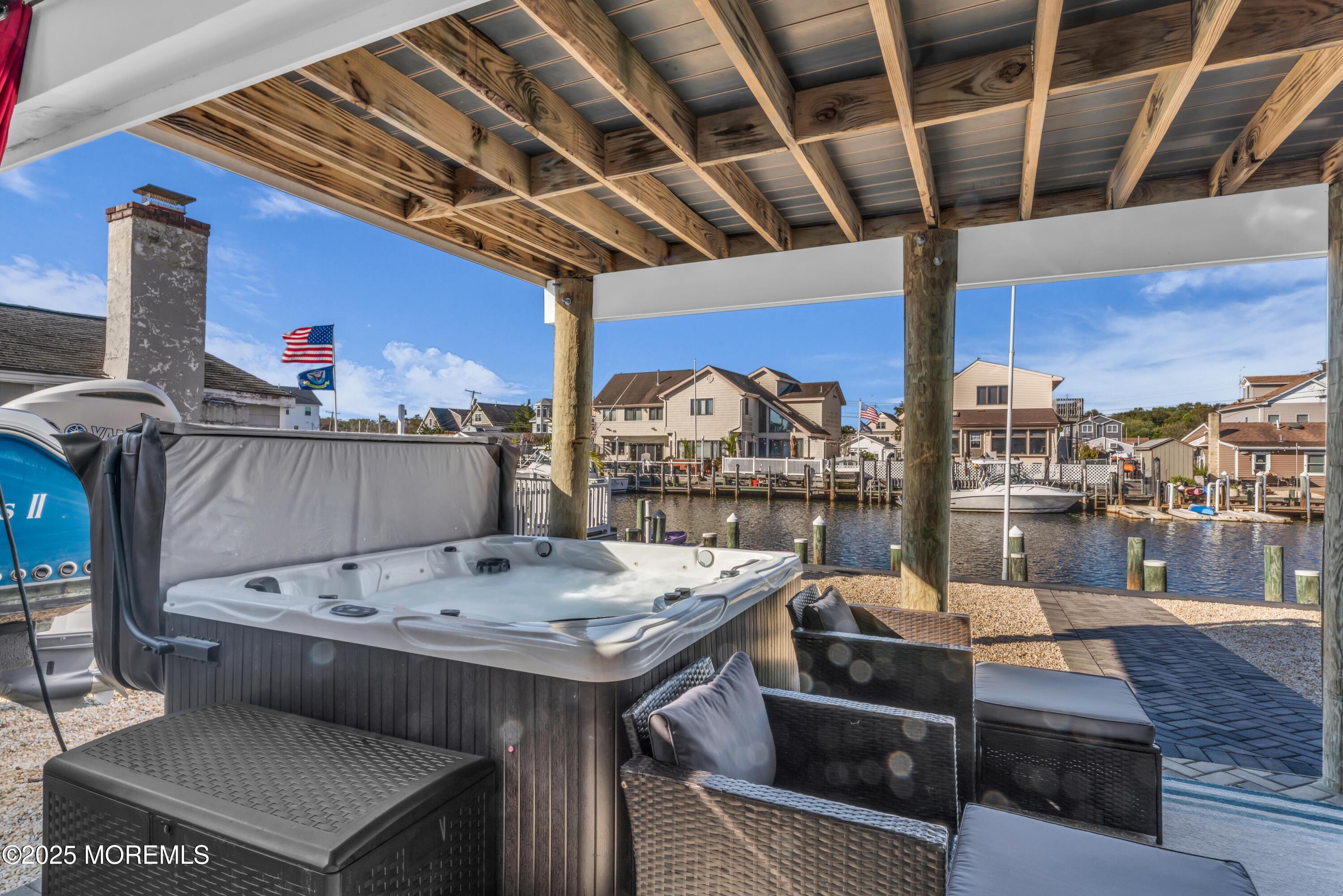 21 Compass Road Waretown, NJ 08758 - Photo 24 of 46 a view of a roof deck with table and chairs