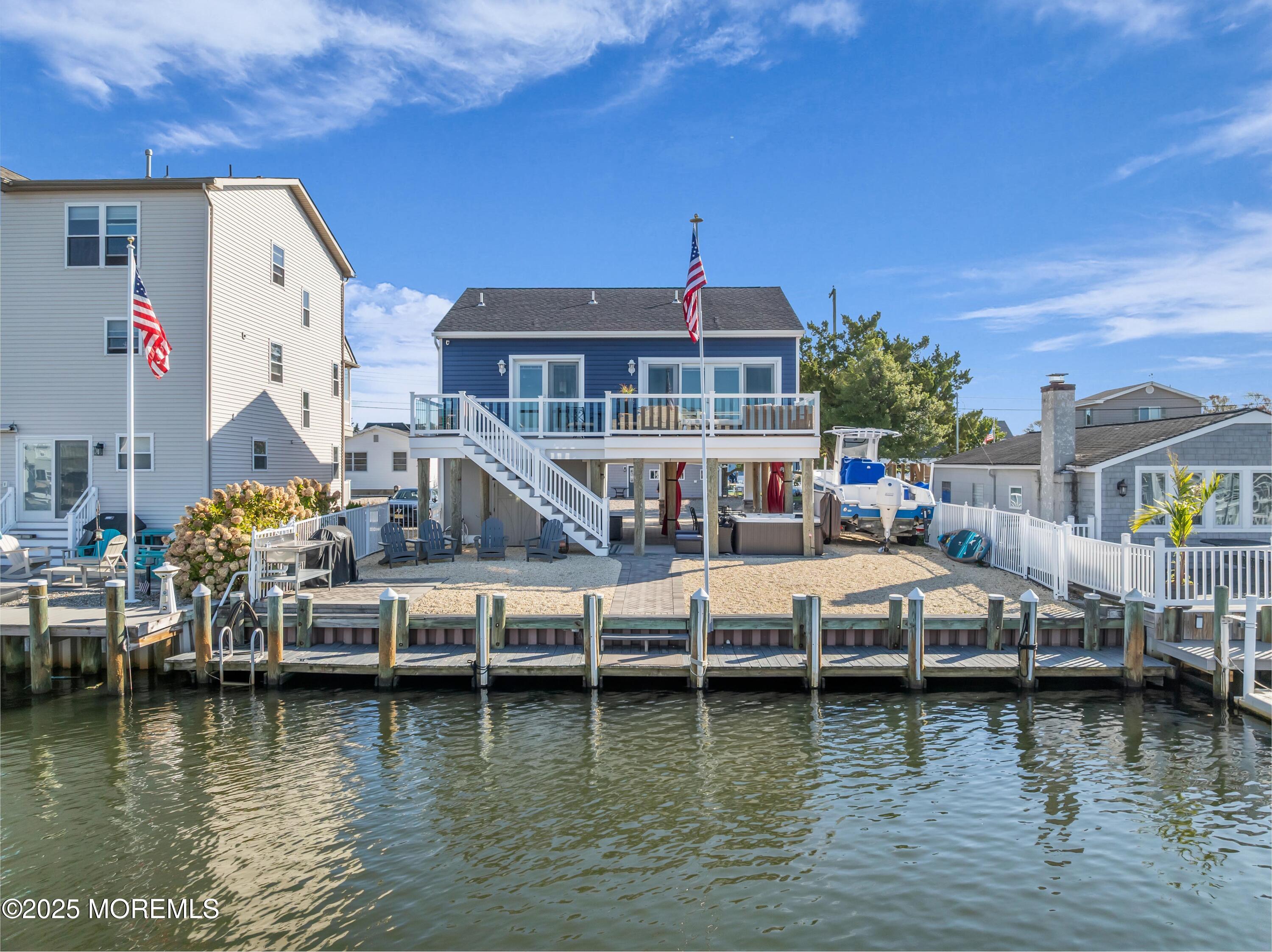 21 Compass Road Waretown, NJ 08758 - Photo 28 of 46 a view of a lake with boats and a house