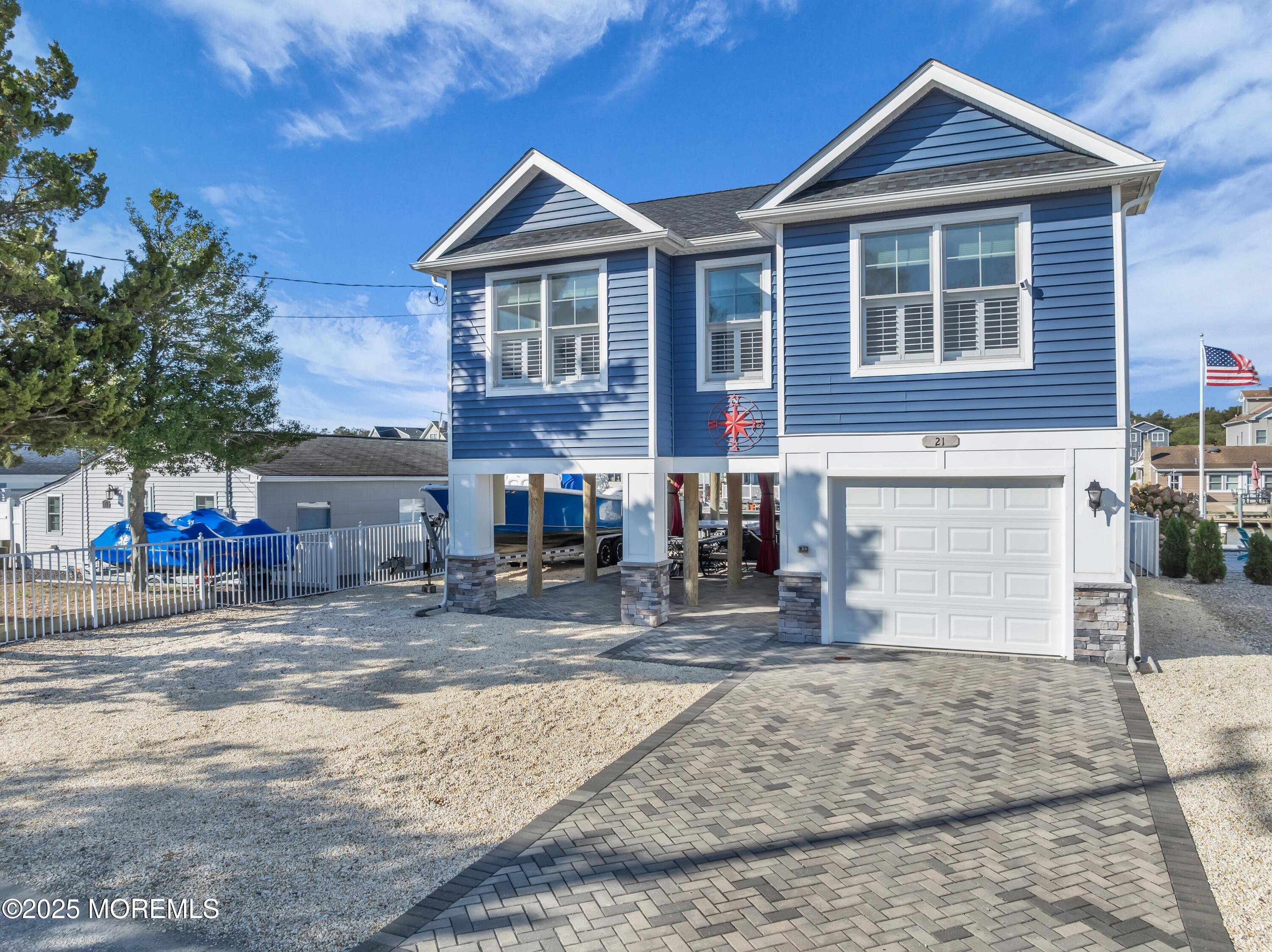 21 Compass Road Waretown, NJ 08758 - Photo 34 of 46 a front view of a house with large windows