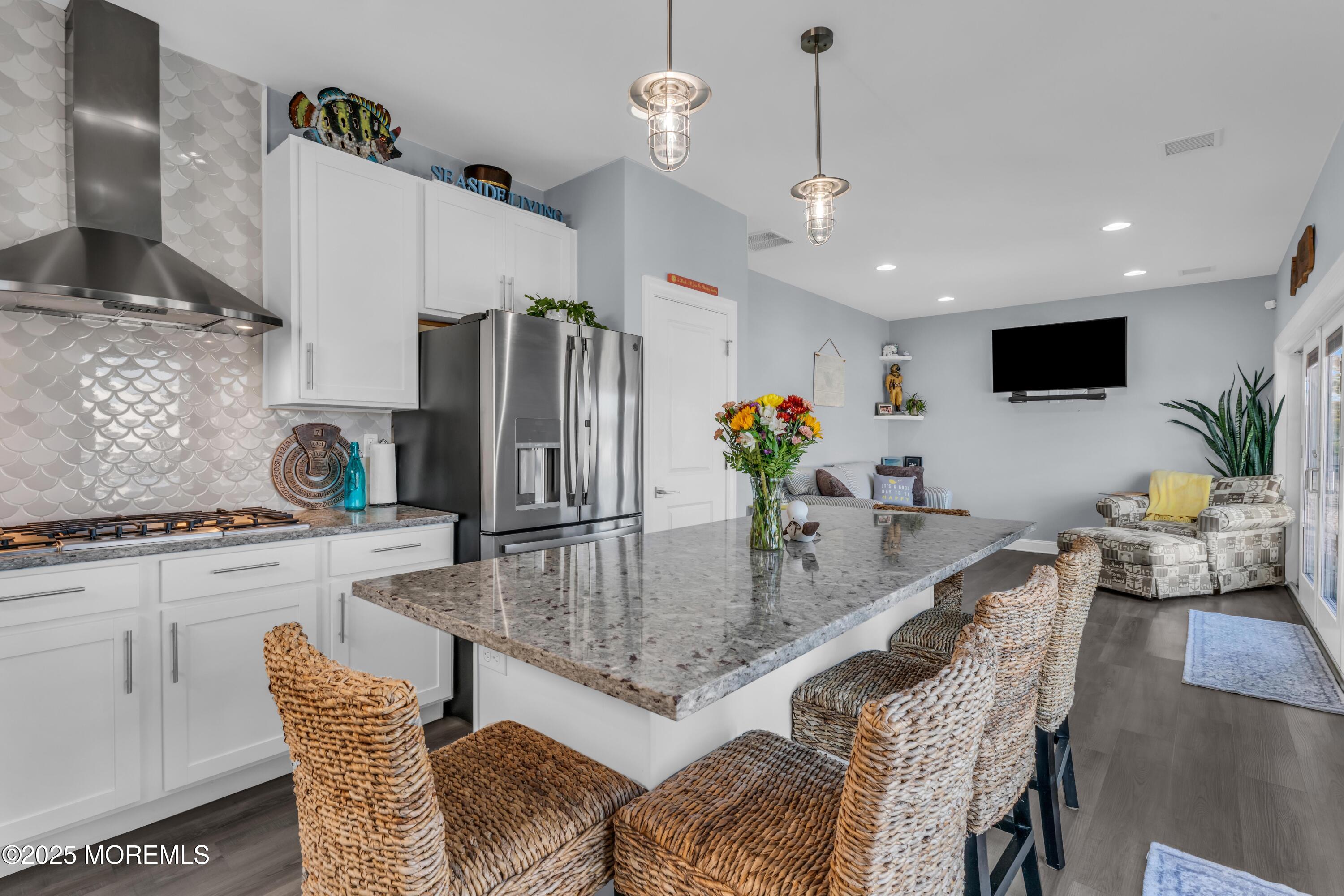 21 Compass Road Waretown, NJ 08758 - Photo 9 of 46 a kitchen with granite countertop kitchen island stainless steel appliances a table and chairs in it