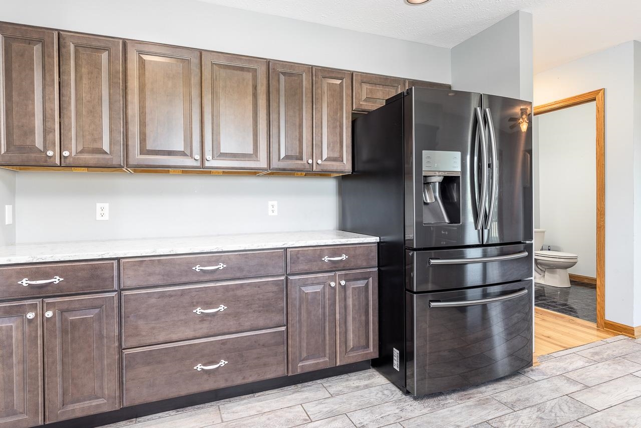4661 North Marrill Road Byron, IL 61010 - Photo 11 of 39 a kitchen with stainless steel appliances granite countertop a refrigerator and cabinets