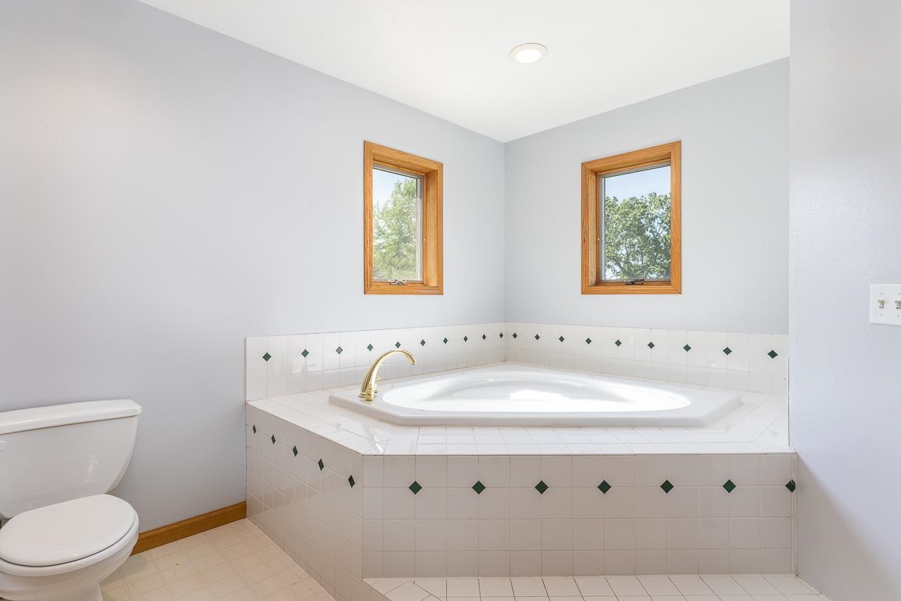 4661 North Marrill Road Byron, IL 61010 - Photo 18 of 39 a bathroom with a sink a toilet and a window