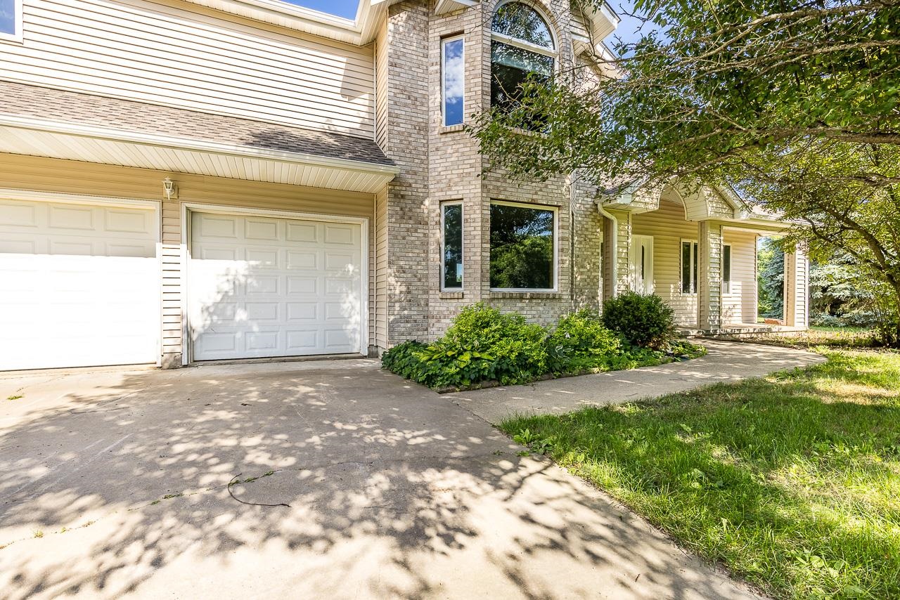 4661 North Marrill Road Byron, IL 61010 - Photo 2 of 39 a front view of a house with garden