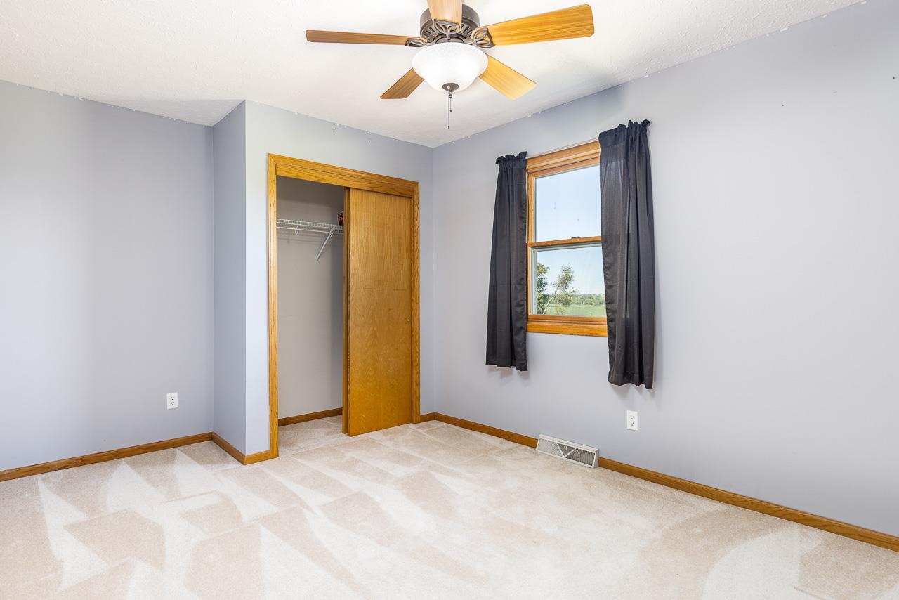 4661 North Marrill Road Byron, IL 61010 - Photo 21 of 39 a view of an empty room with window and chandelier fan