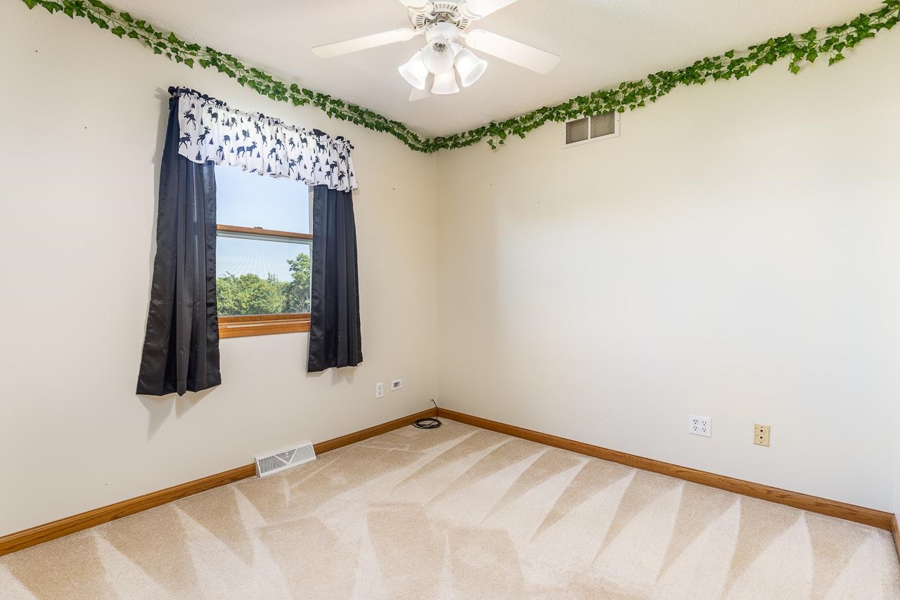 4661 North Marrill Road Byron, IL 61010 - Photo 22 of 39 a view of a room with a window and a ceiling fan