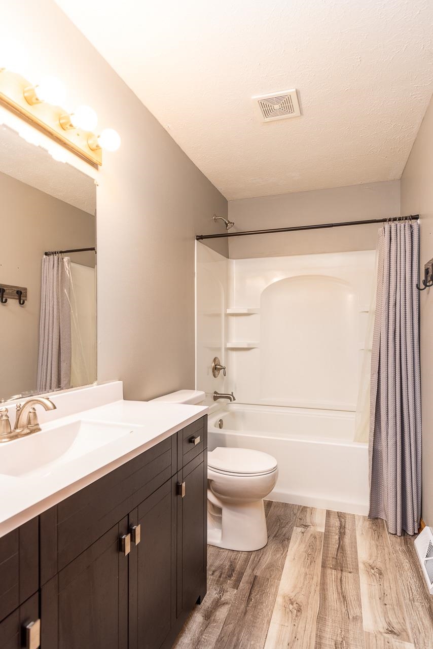 4661 North Marrill Road Byron, IL 61010 - Photo 24 of 39 a bathroom with a sink a toilet a mirror and shower