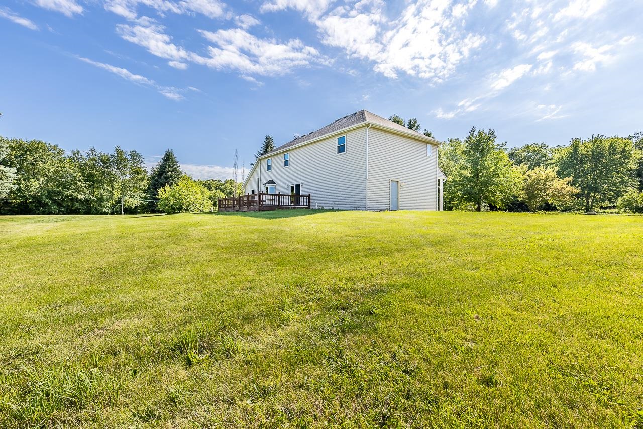 4661 North Marrill Road Byron, IL 61010 - Photo 27 of 39 a view of a big room with yard and a large tree