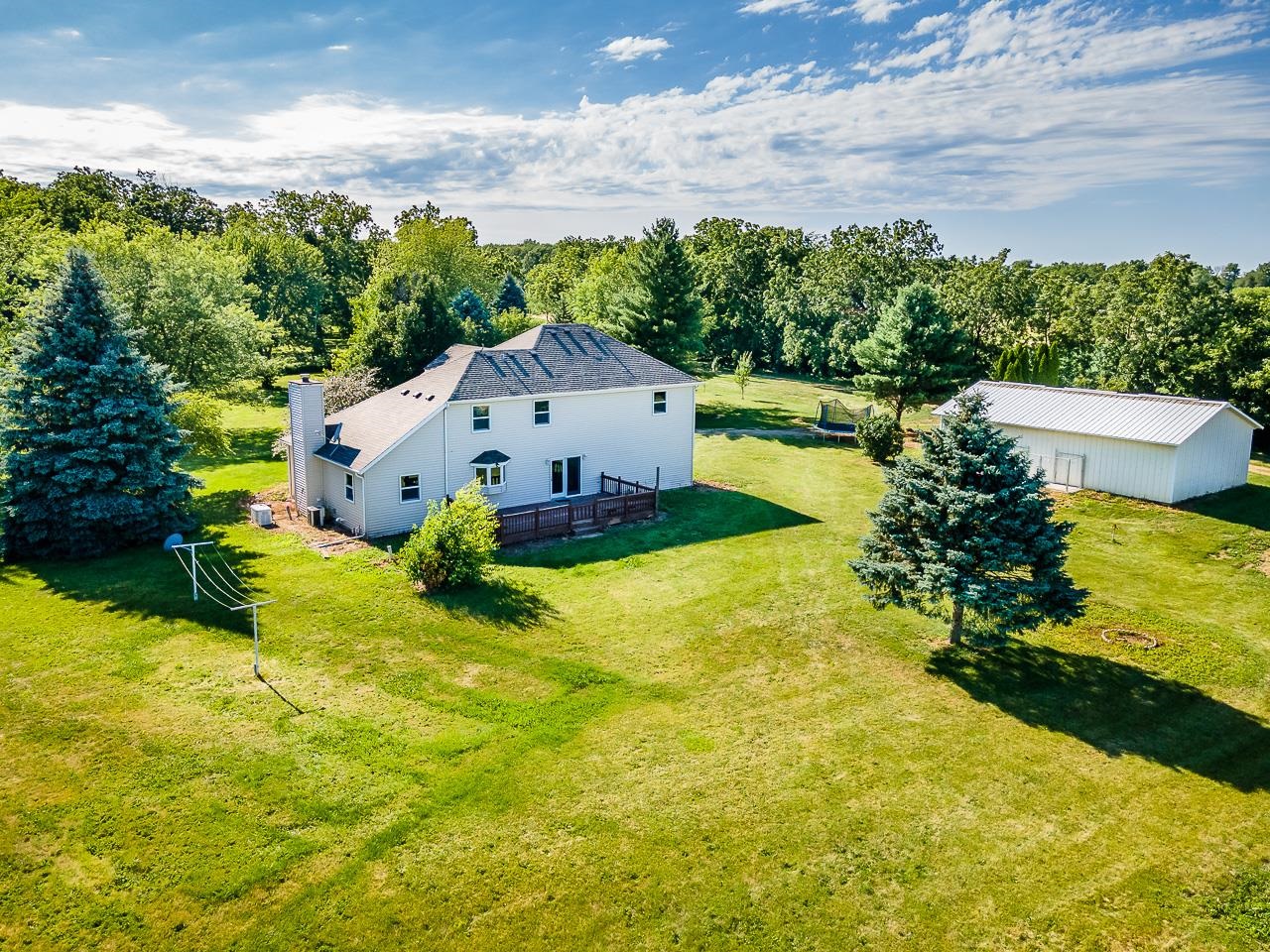 4661 North Marrill Road Byron, IL 61010 - Photo 28 of 39 a house with swimming pool in front of it