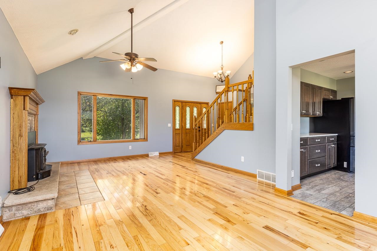 4661 North Marrill Road Byron, IL 61010 - Photo 5 of 39 a view of a bedroom with wooden floor and a ceiling fan