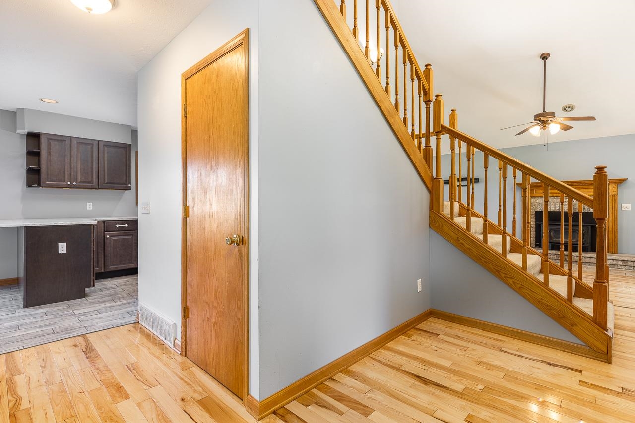 4661 North Marrill Road Byron, IL 61010 - Photo 7 of 39 a view of hallway with stairs and wooden floor