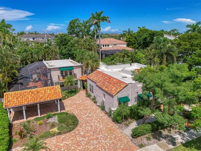 an aerial view of a house with a yard and sitting area