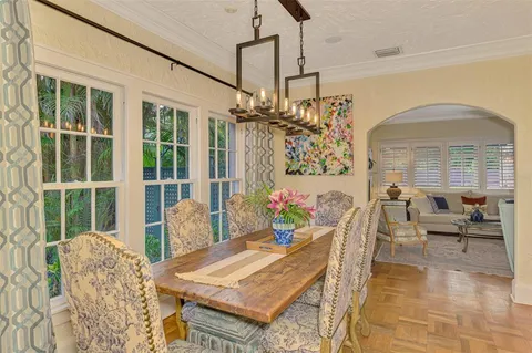 a view of a dining room with furniture and a chandelier