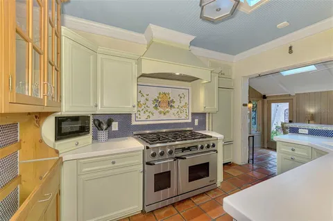 a kitchen with stainless steel appliances a stove a sink and a refrigerator