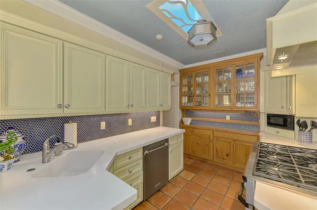 a kitchen with a sink cabinets and wooden floor