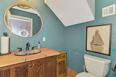 a kitchen with granite countertop white cabinets and stainless steel appliances