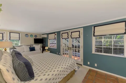 a view of patio with table and chairs under an umbrella