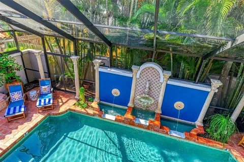 a bedroom with a bed and a table with potted plant