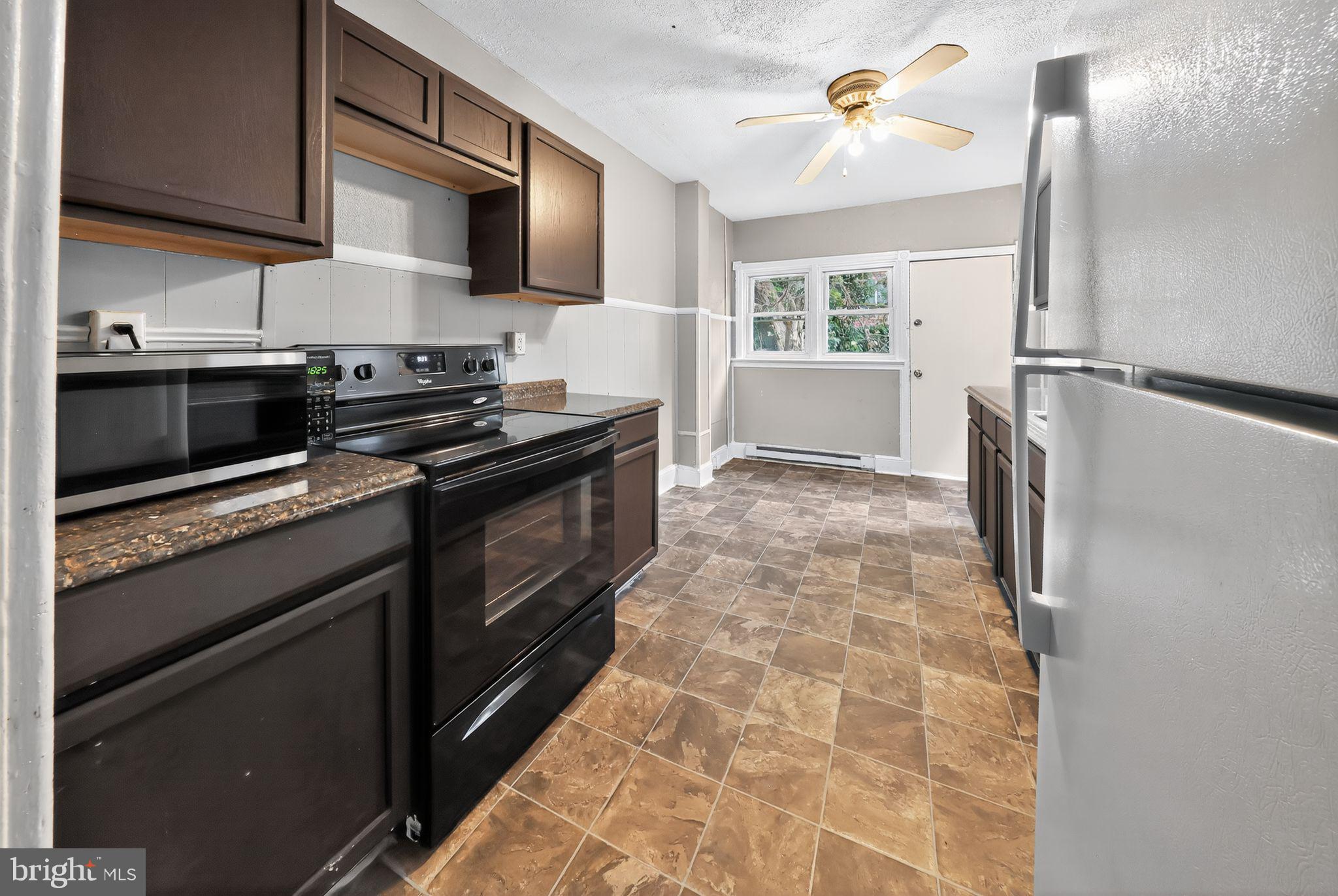 11 East 24th Street Wilmington, DE 19802 - Photo 14 of 31 a kitchen with stainless steel appliances a stove microwave and a sink